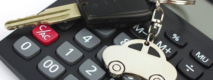car keys on top of a calculator