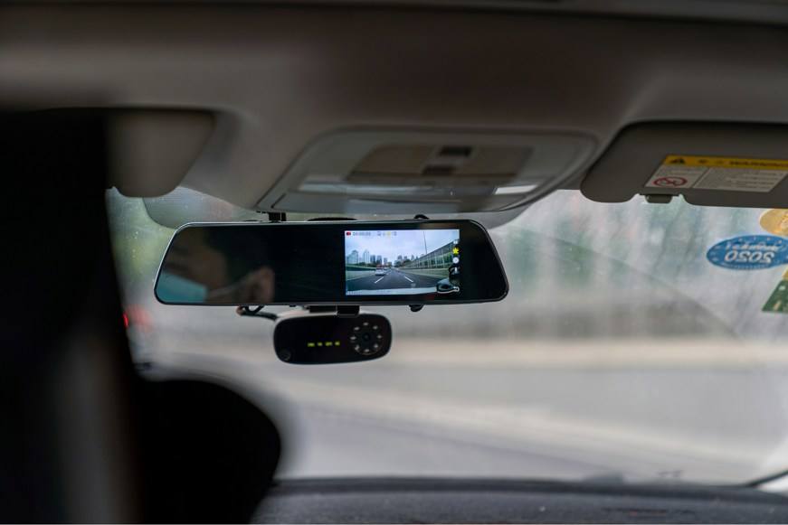 Dash cam attached below car rear view mirror