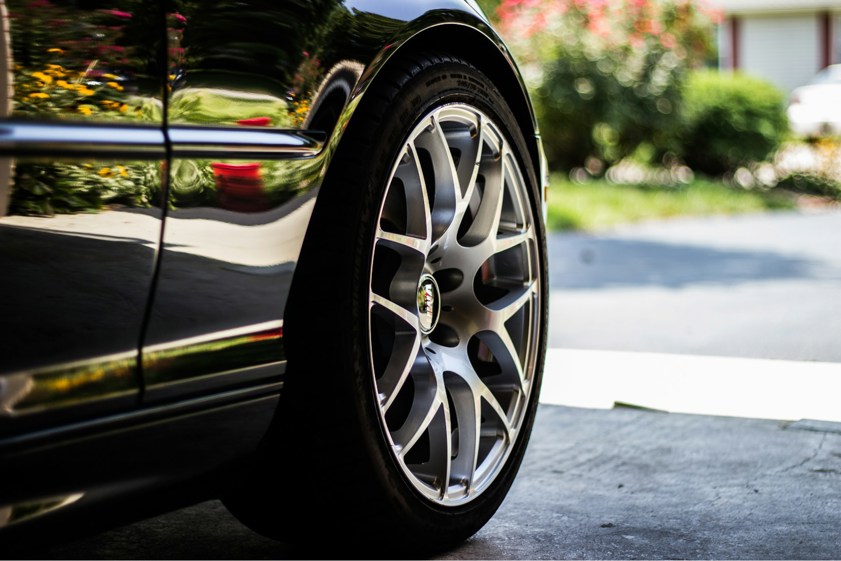 Black car with grey alloy wheels