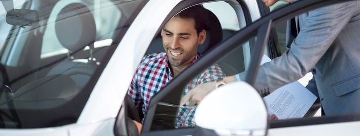 Customer being shown features of new car