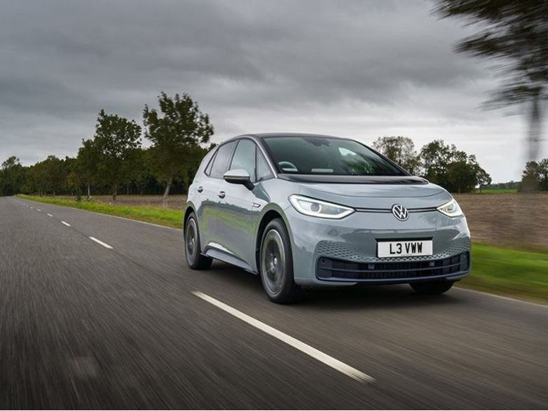 grey volkswagen id.3 driving on the road