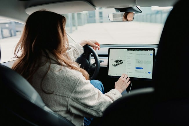 woman driving tesla