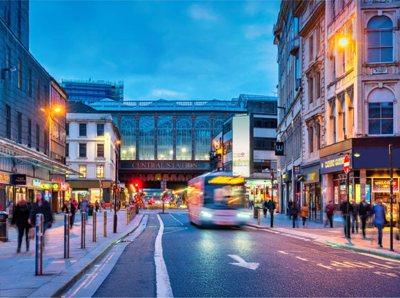 Argyle Street and Glasgow Central Station in downtown Glasgow, Scotland at night.