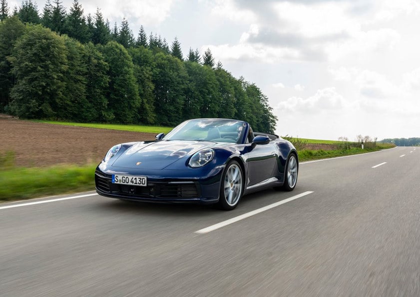 Porsche 911 Carrera Cabriolet driving on the road