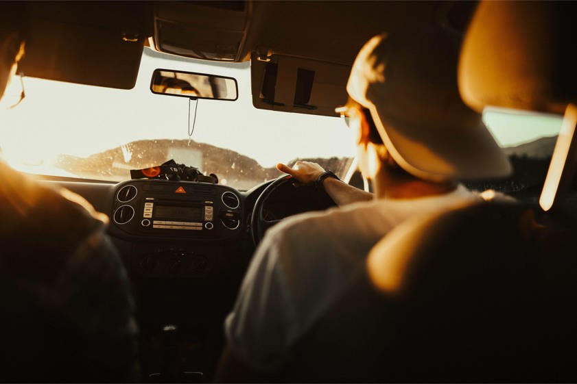 Man Holding the Steering Wheel While Driving