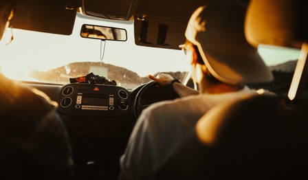 Man Holding the Steering Wheel While Driving