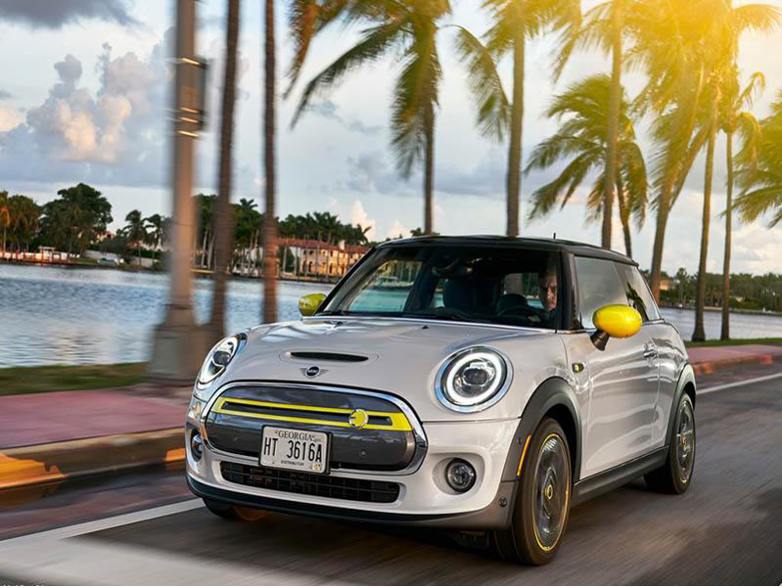 silver mini cooper Electric Hatchback driving on road