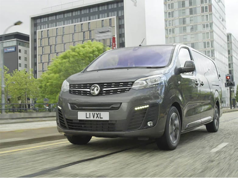 black vauxhall vivaro-e driving on the road