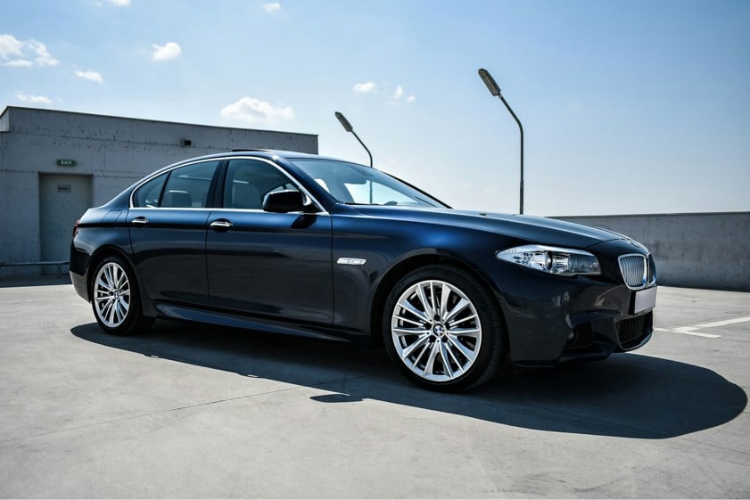 Black BMW Saloon car from side on with silver alloy wheels