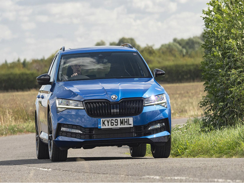 blue skoda superb estate driving