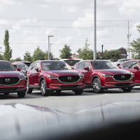 a row of cars parked in a parking lot