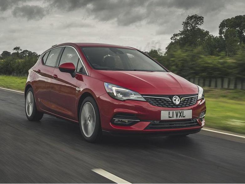 red vauxhall astra driving on road