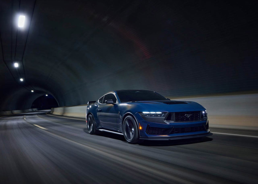 Ford Mustang driving on the road