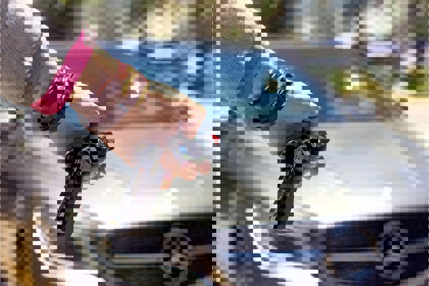 Person using car keys to open mercedes-benz car