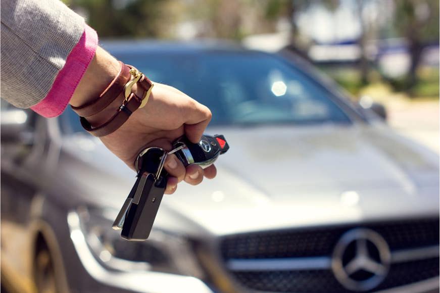 Person using car keys to open mercedes-benz car