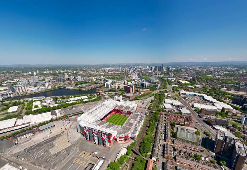 Old Trafford football ground with the city of Manchester in the background