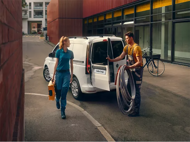 man and woman unloading a volkswagen caddy