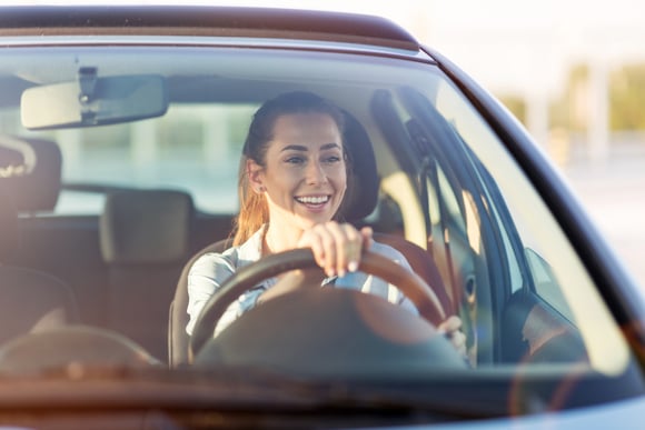 Woman driving car in the sunset