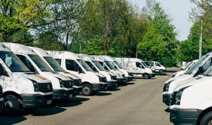 a fleet of vans parked in a car park