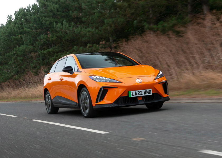 Orange MG4 EV driving on the road