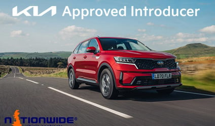 A Kia Sportage driving on the road with a badge for Kia Approved Introducer.