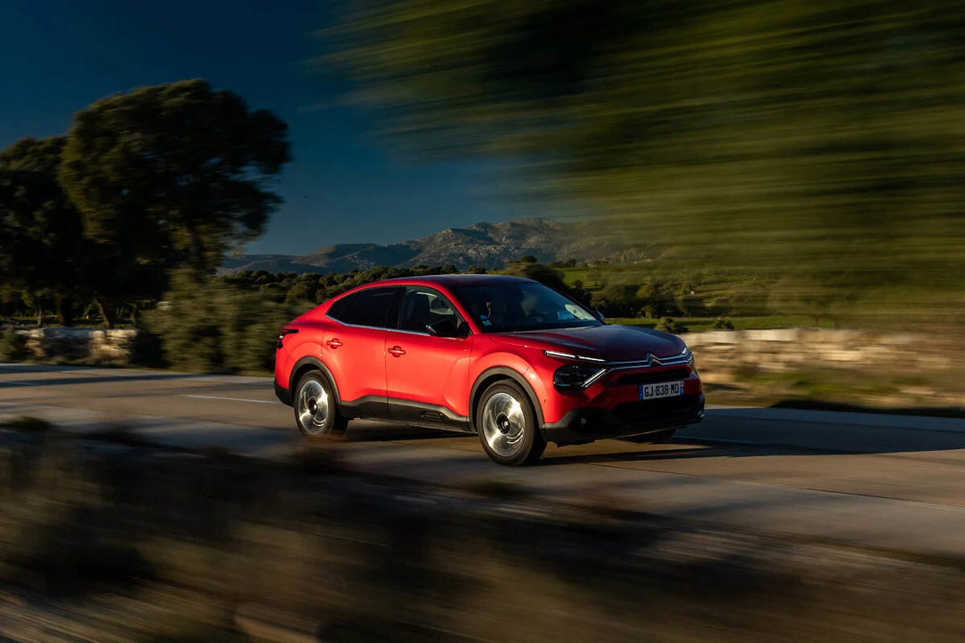 Citroen C4 X in red driving on the road