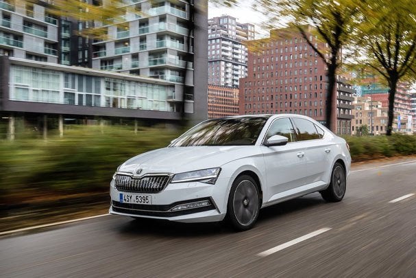 White Skoda Superb 2023 driving on the road 