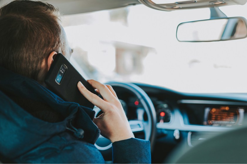 man answering phone when driving