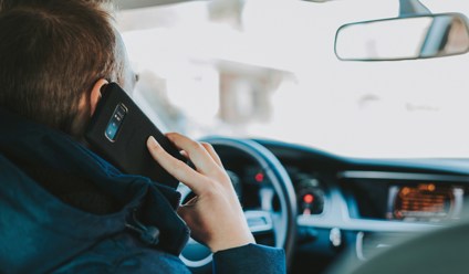 man answering phone when driving