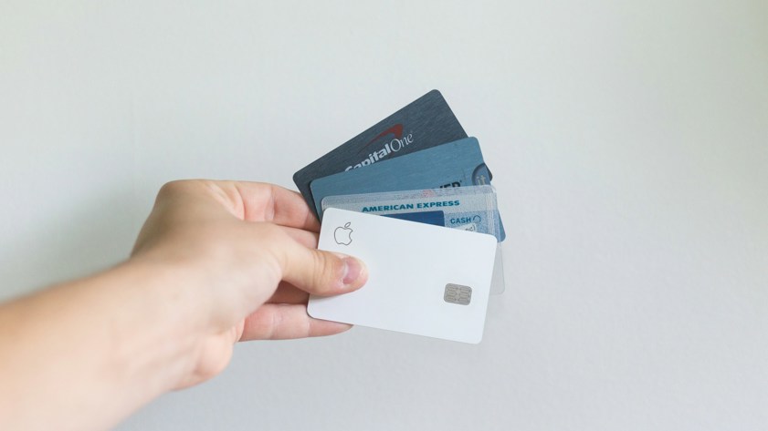 person holding multiple credit cards