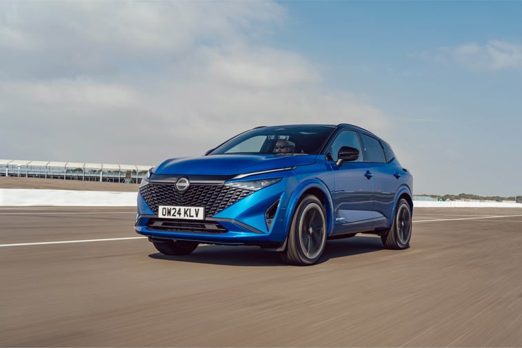 Nissan Qashqai in blue driving on the road