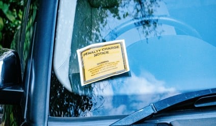 a car with a yellow sign attached to its window