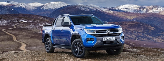 Volkswagen Amarok pickup truck parked on a rugged mountain trail