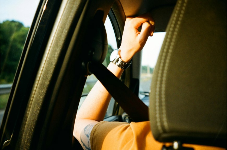 Person sitting in car with seat belt on