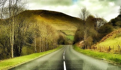 A photo of the Brecon Beacons in Wales, showing a mountain range and green valleys.