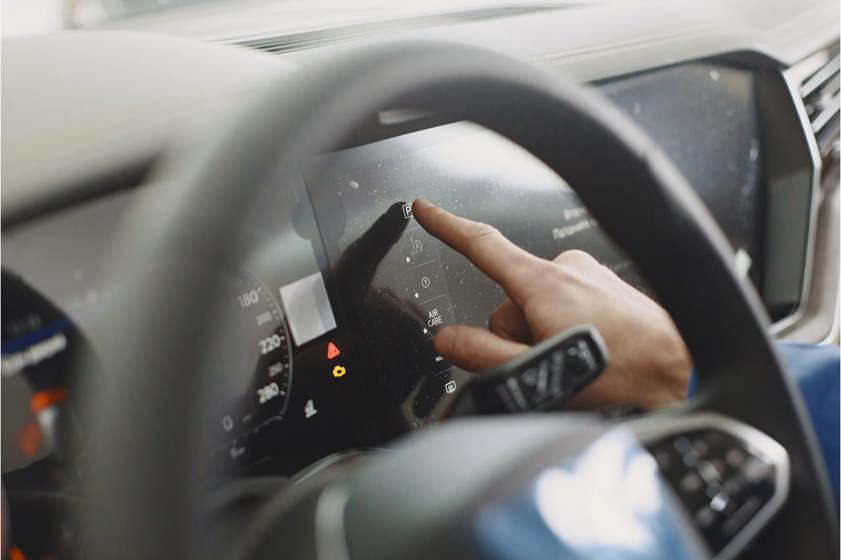 Driver touching their dashboard display