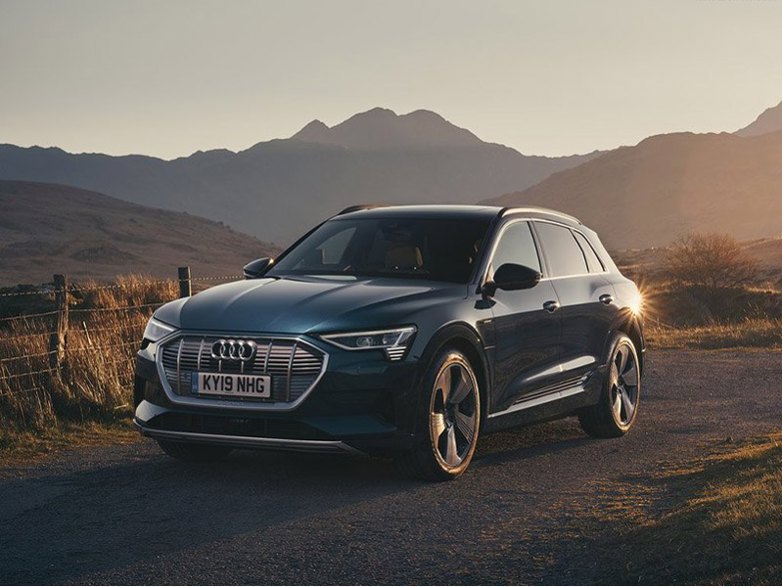 black audi e-tron estate on dirt road