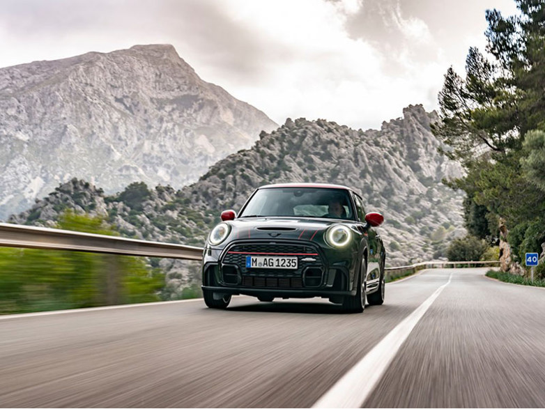 mini hatchback driving on road