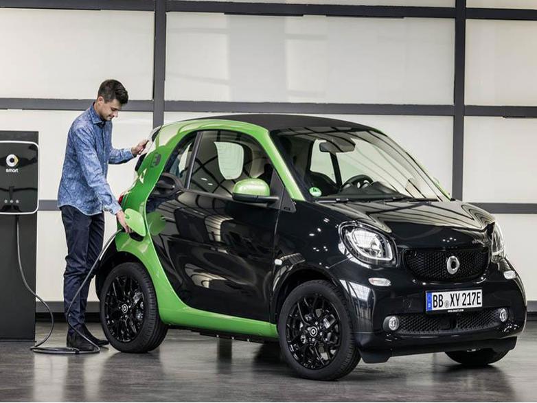 black smart fourtwo coupe ev being charged