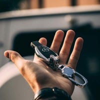 close up of man holding car key