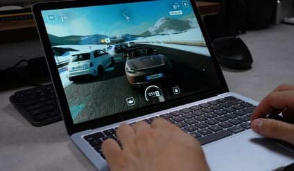 person playing a racing game on a laptop