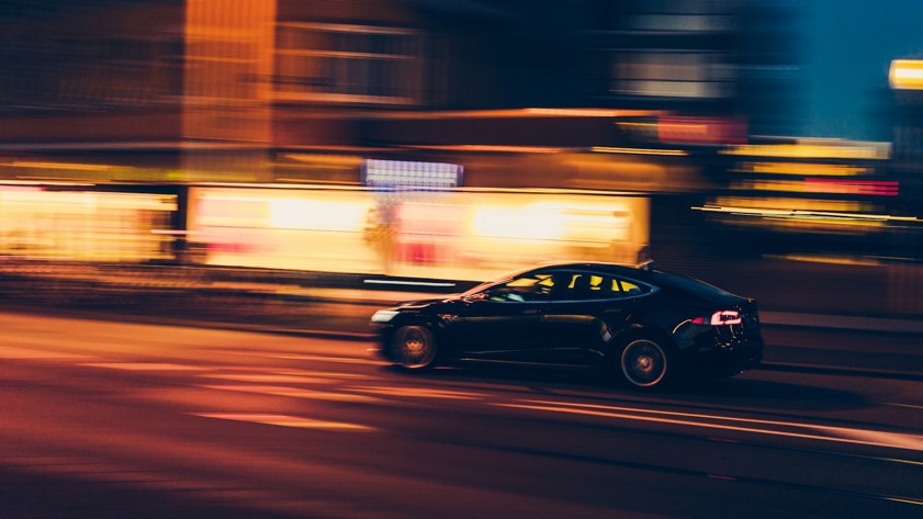 Saloon car driving at night with time span effect