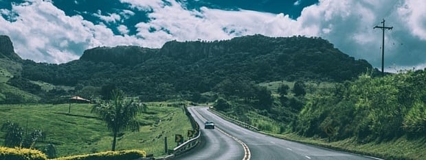 Road winding through a lush green valley