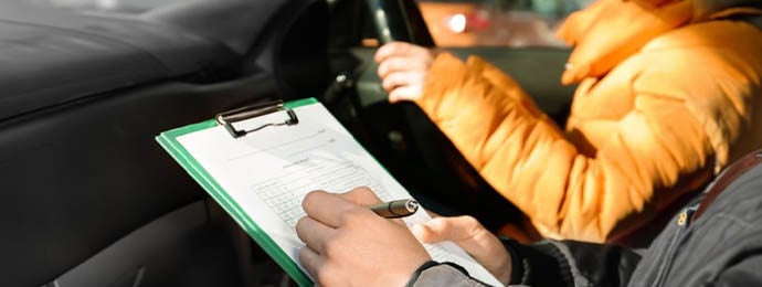 Driving examiner marking a drivers driving