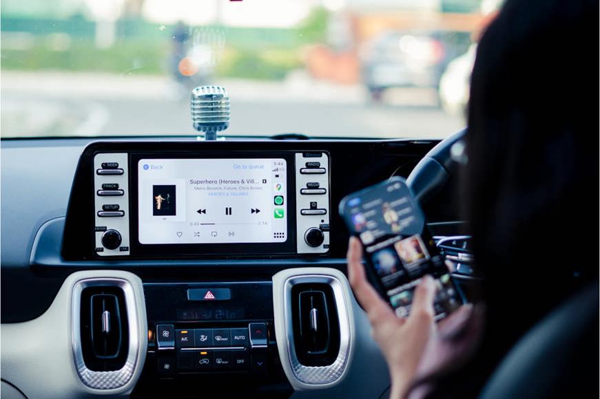 Driver connecting their music to their cars infotainment system