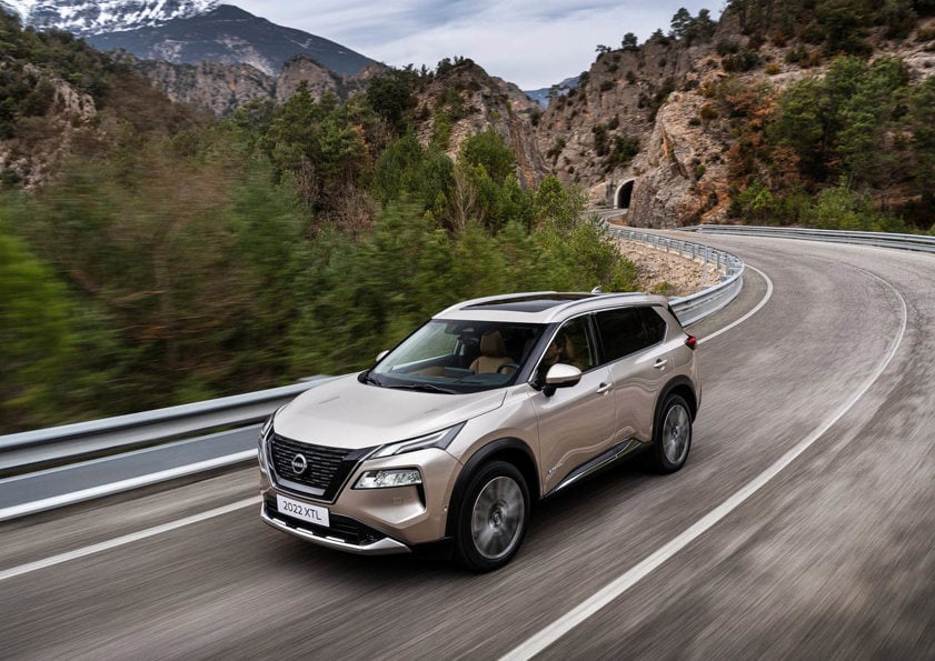 Nissan X-Trail in silver driving on the road