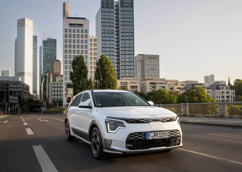 White Kia Niro Hybrid driving on the road