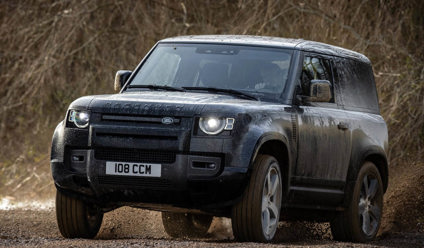 Black Land Rover Defender driving off road