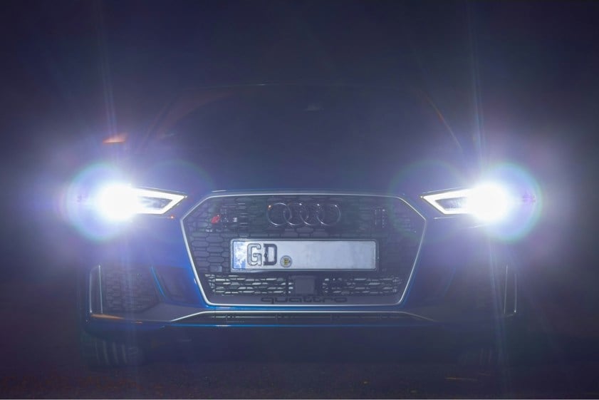 Audi car with headlights on in the dark