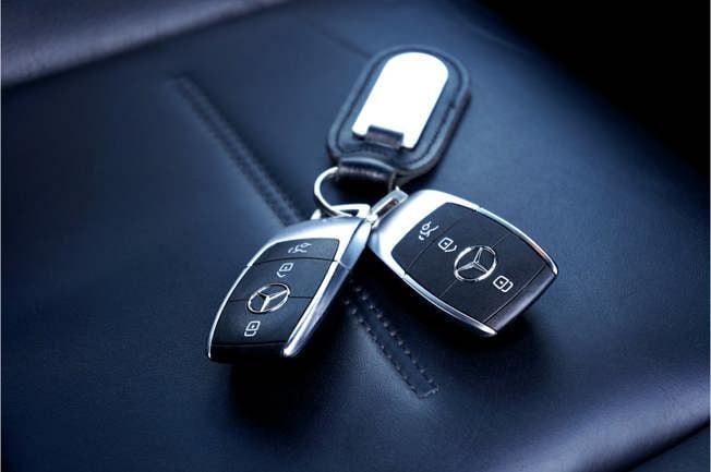 Black Mercedes car keys on a seat